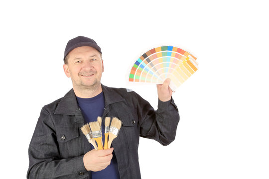 Worker with color samples and brushes.