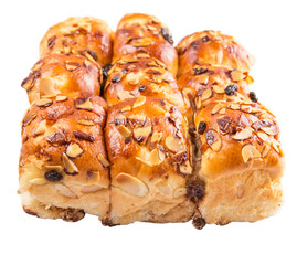 Homemade sweet bun with almond and raisins on a white plate