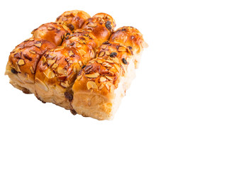 Homemade sweet bun with almond and raisins on a white background