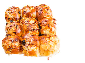 Homemade sweet bun with almond and raisins on a white background