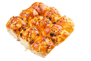 Homemade sweet bun with almond and raisins on a white background