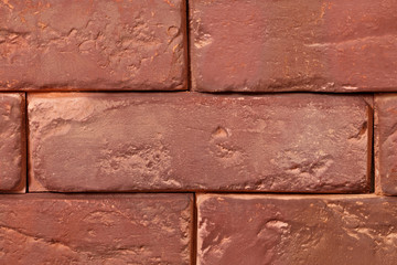Abstract surface of an old red brick.