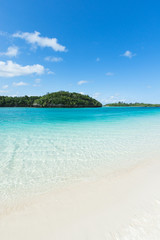 Tropical paradise beach and clear blue lagoon water
