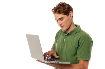 Handsome guy operating laptop