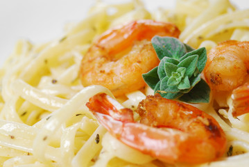 Pasta with shrimps and sauce on the wooden table