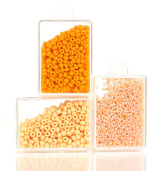 Colorful beads heap in boxes isolated on white