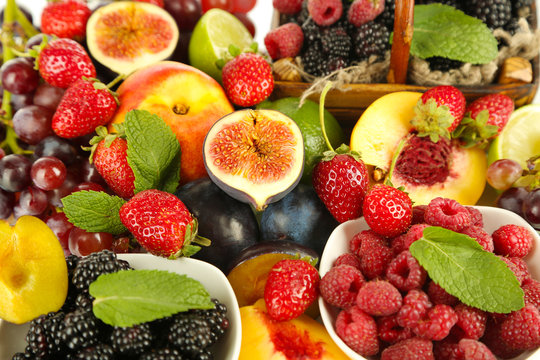 Assortment of juicy fruits and berries background
