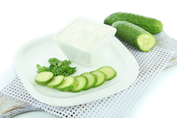 Cucumber yogurt in bowl, on white, isolated on white