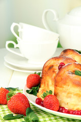 Tasty homemade cake with berries, on table