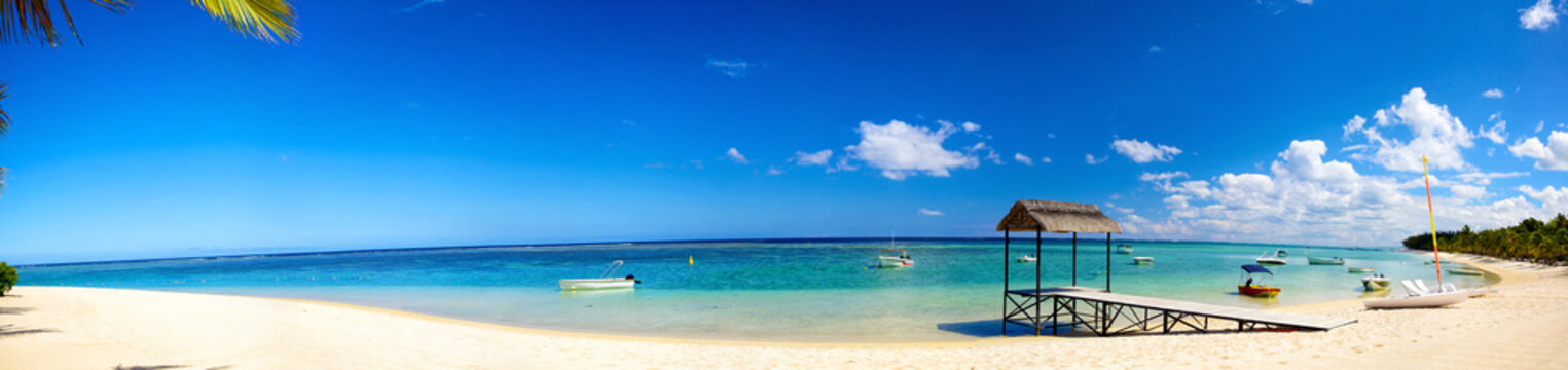 Panoramic View Of Tropical Beach With Jetty And Boats