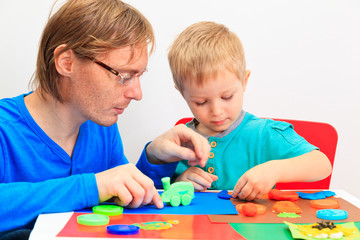 father and son playing with clay dough