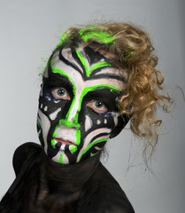 The girl in an unusual dance image, painted in dark colors