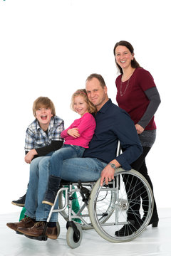 man in wheelchair with family
