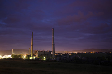 industrial landscape with towers at night