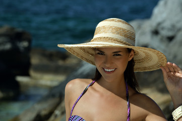 Portrait of smiling brunette model at tropical location