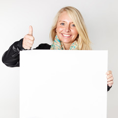 Woman with message board shows thumb up