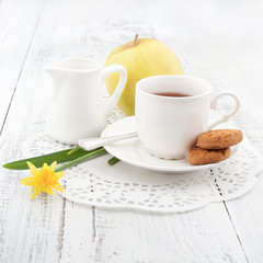 Breakfast with homemade cookies and apple, with cup of tea