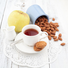 Breakfast with homemade cookies, apple and nuts with cup of tea