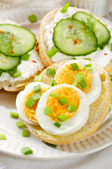 Fresh canapes with egg, cottage cheese, cucumber and herbs