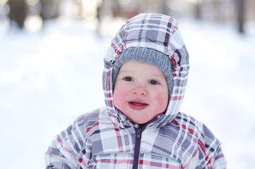 smiling baby with rosy cheeks in wintertime