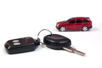 Car keys with red car in background