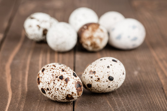 Quail eggs on a brown wooden table