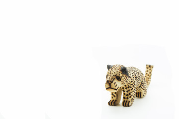 wooden mini figure of a leopard isolated on white background