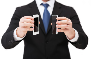 businessman showing smartphones with blank screens