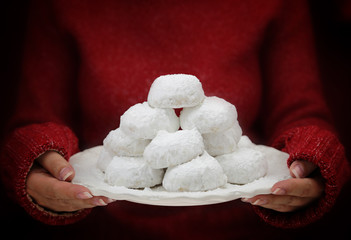 Female hands holding traditional Greek butter cookies