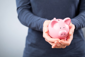 Care for Savings - Woman with a Piggy Bank