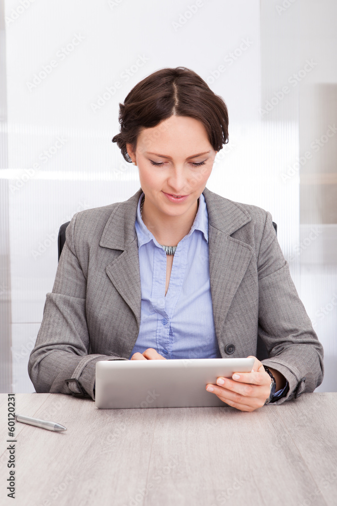 Wall mural smiling young businesswoman using digital tablet