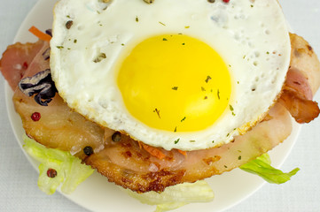 Burger with fried eggs and bacon