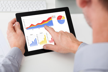 Businessman Analyzing Graph On Digital Tablet
