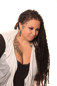 Tattooed woman  with piercings and dreadlocks