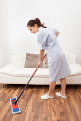 Young Maid Cleaning Floor