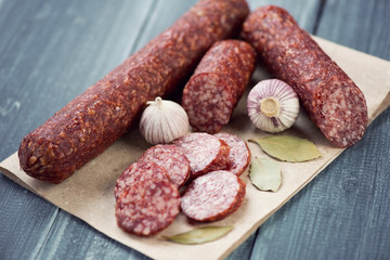 Salami, garlic and bay leaves, horizontal shot