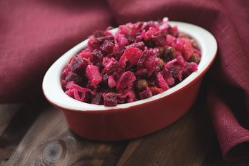 Bowl with traditional russian beetroot salad, horizontal shot
