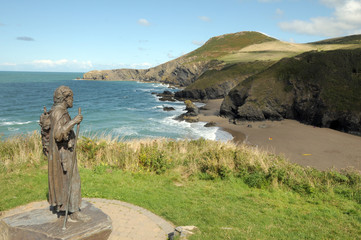 Statue overlooking bay at Llangrannog in Cardigan
