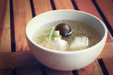 Chicken soup on a wooden table