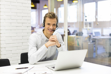Businessman in the office on the phone with headset, Skype