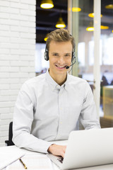 Businessman in the office on the phone with headset, Skype