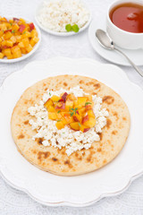 Flat bread with cottage cheese with honey, nuts, peaches