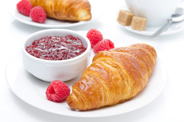 fresh croissant, raspberry and jam for breakfast