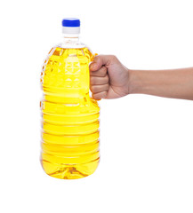 Female hand holding cooking oil in a plastic container