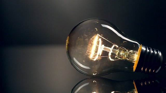 Light bulb on black background