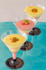 Passion fruit and strawberry mousse on blue plate