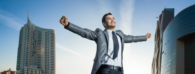 Successful businessman with his arms wide open - obrazy, fototapety, plakaty