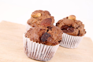 Chocolate muffins on a wooden board