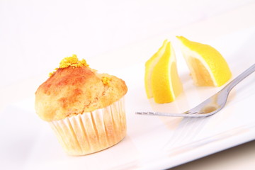 Lemon muffin and lemon pieces on a plate