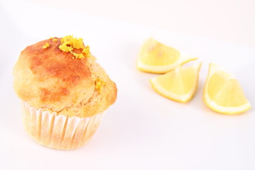 Lemon muffin and lemon pieces on a plate